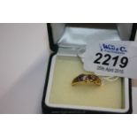 An 18ct Gold boat shaped Diamond and Sapphire Ring with decorative scroll work sides