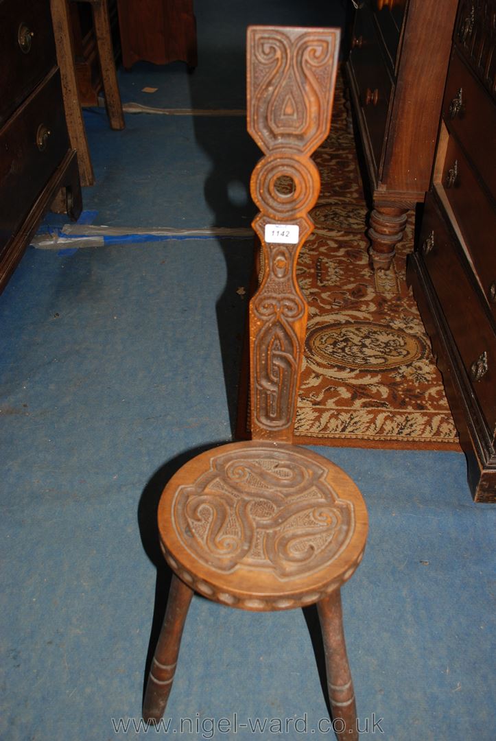 A three legged Spinning Chair with Celtic style carved decoration