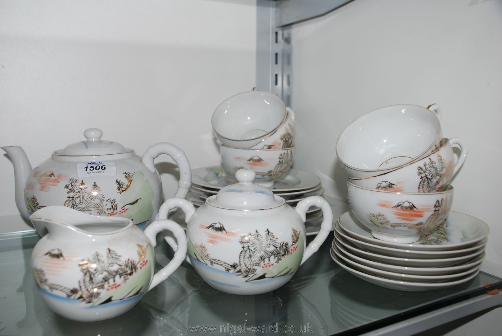 An oriental china Teaset with face of Geisha girl lithophane to the base of the tea cups.