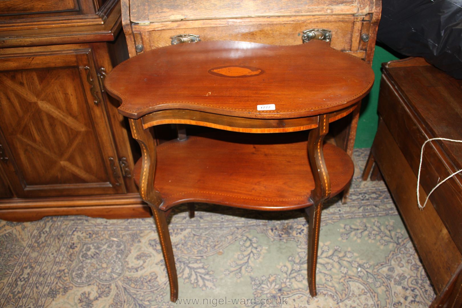 An elegant Edwardian Mahogany two tier occasional Table having stylized 'S' shaped top and lower