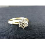 9 ct gold daisy cluster ring set with 0.33 ct of diamonds. Size N.