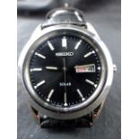 Seiko Solar gents wristwatch on leather strap. Working at lotting up.