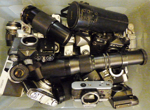 Box of cameras and lenses. Canon, Yashica, Fujica, Pentagon Lenses etc