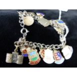 Silver charm bracelet with place names.