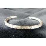 Sterling silver solid patterned torq bangle.