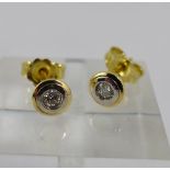 18ct yellow gold diamond studs with white gold rub over setting.