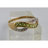 9 ct gold peridot & white stone crossover ring. Size O.