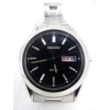 Seiko Solar day date gents wristwatch on stainless steel bracelet.