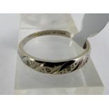 9ct white gold band set with diamonds across the top. Size L