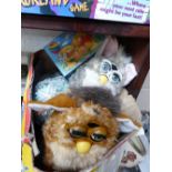 Box containing two Furbie toys and various jigsaws