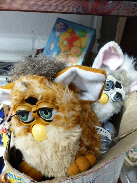 Box containing two Furbie toys and various jigsaws