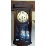 Oak cased chiming wall clock with glazed front, with pendulum and key