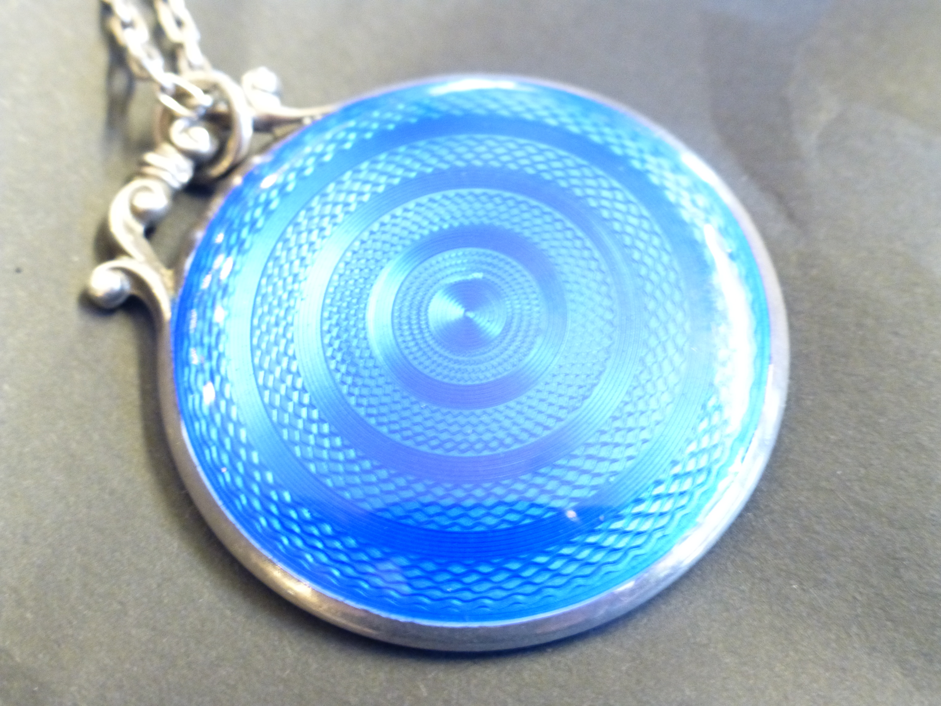 Hallmarked silver guilloche enamel backed mirror pendant.