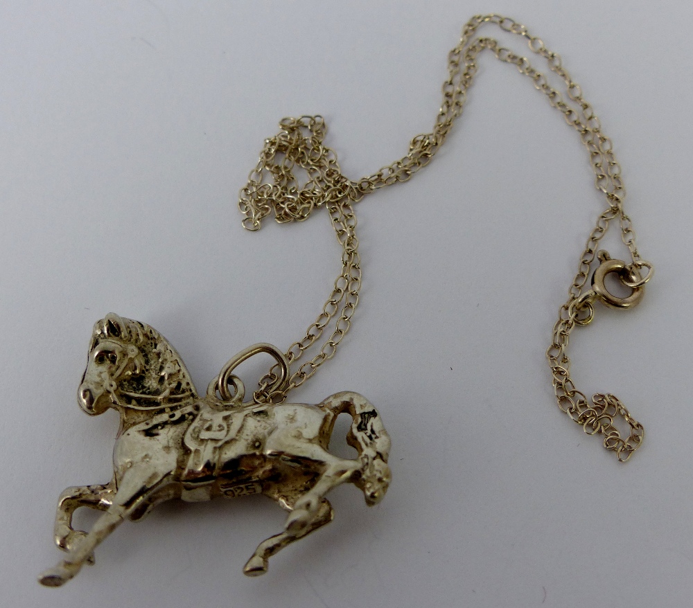 Sterling silver horse pendant on chain.