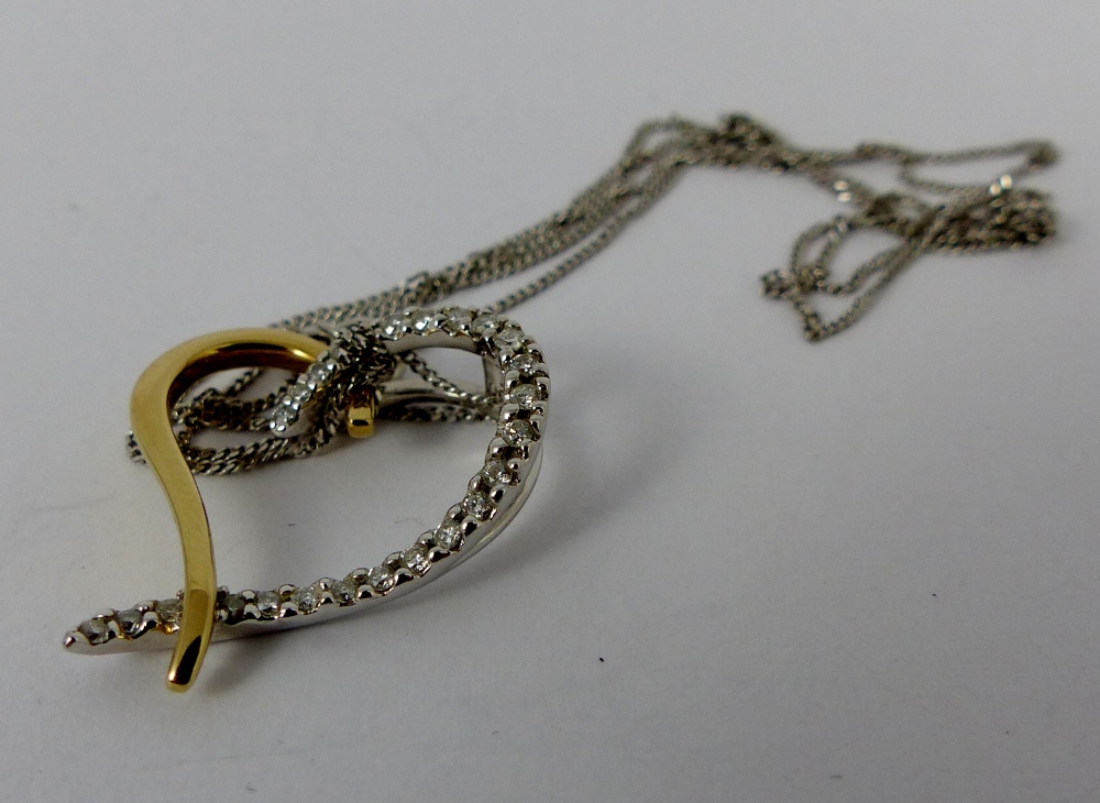 9ct yellow and white gold, 0.25ct diamond heart pendant on 9ct gold chain