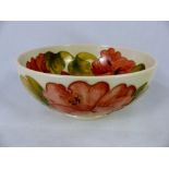 Moorcroft Hibiscus pattern bowl on cream ground signed WM in green to base, D 16cm