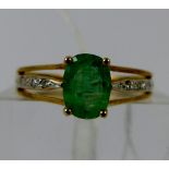 9 ct gold emerald ring with diamond set shoulders. Size N.