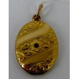 Victorian yellow metal red stone set locket.