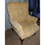 Upholstered armchair on cabriole feet