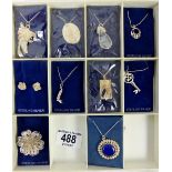 Nine silver and white metal pendants and chains and a brooch as new