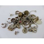 Silver and white metal rings, bracelet charms, earrings etc Total: 80gms