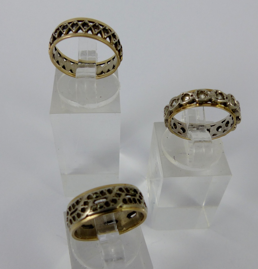 Three gold and silver rings, two size J and one size K