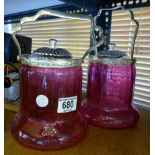 Two cranberry style glass biscuit barrels