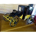 Old tin model of hansom cab with sprung suspension and steering mounted on base, H ~ 18.5cm