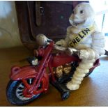 Cast iron Michelin Man on motorbike