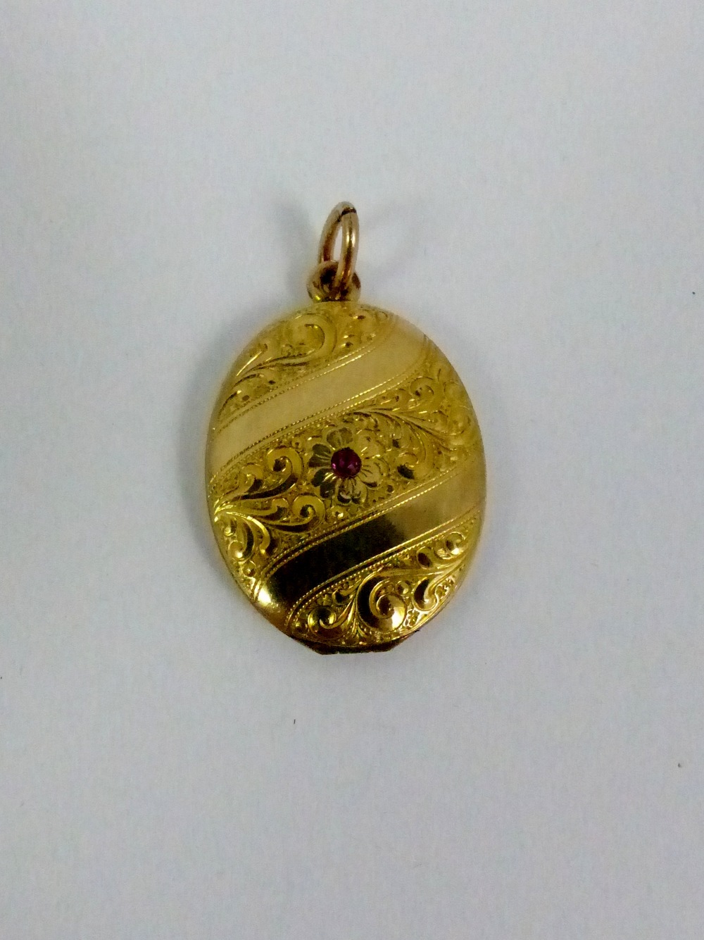 Victorian yellow metal red stone set locket