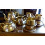 Oriental gold laquered tray with matching fifteen piece tea set