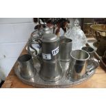 Silver plate and pewter coffee jugs on a tray