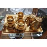 Oriental gold laquered tray with matching fifteen piece tea set