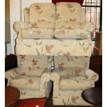 Floral upholstered three piece suite with two seater settee and two armchairs