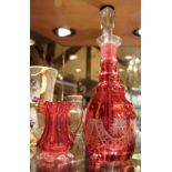 Cranberry etched decanter with stopper and further cranberry jug