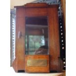 1930s oak pipe smokers cabinet with glass front door and earthenware jar