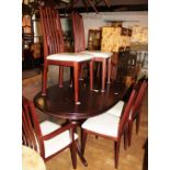 Morris of Glasgow oval extending dining table with six chairs including two carvers, seat pads still