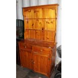 Pine dresser with two drawers over two cupboards