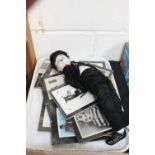 Tray of glazed Charlie Chaplin photographs and glazed porcelain Charlie Chaplin doll