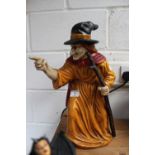 Hollow metal figurine depicting witch with broom