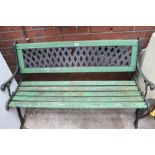 Painted green garden bench with wrought iron ends
