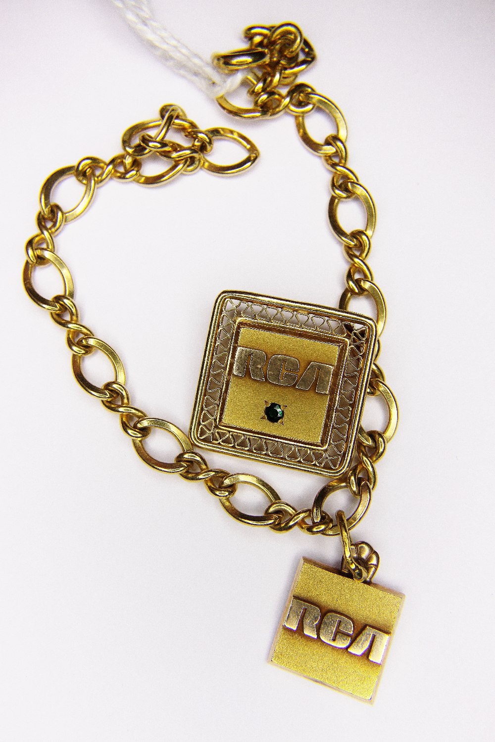 GOLD BRACELET. 10k gold bracelet and badge from RCA