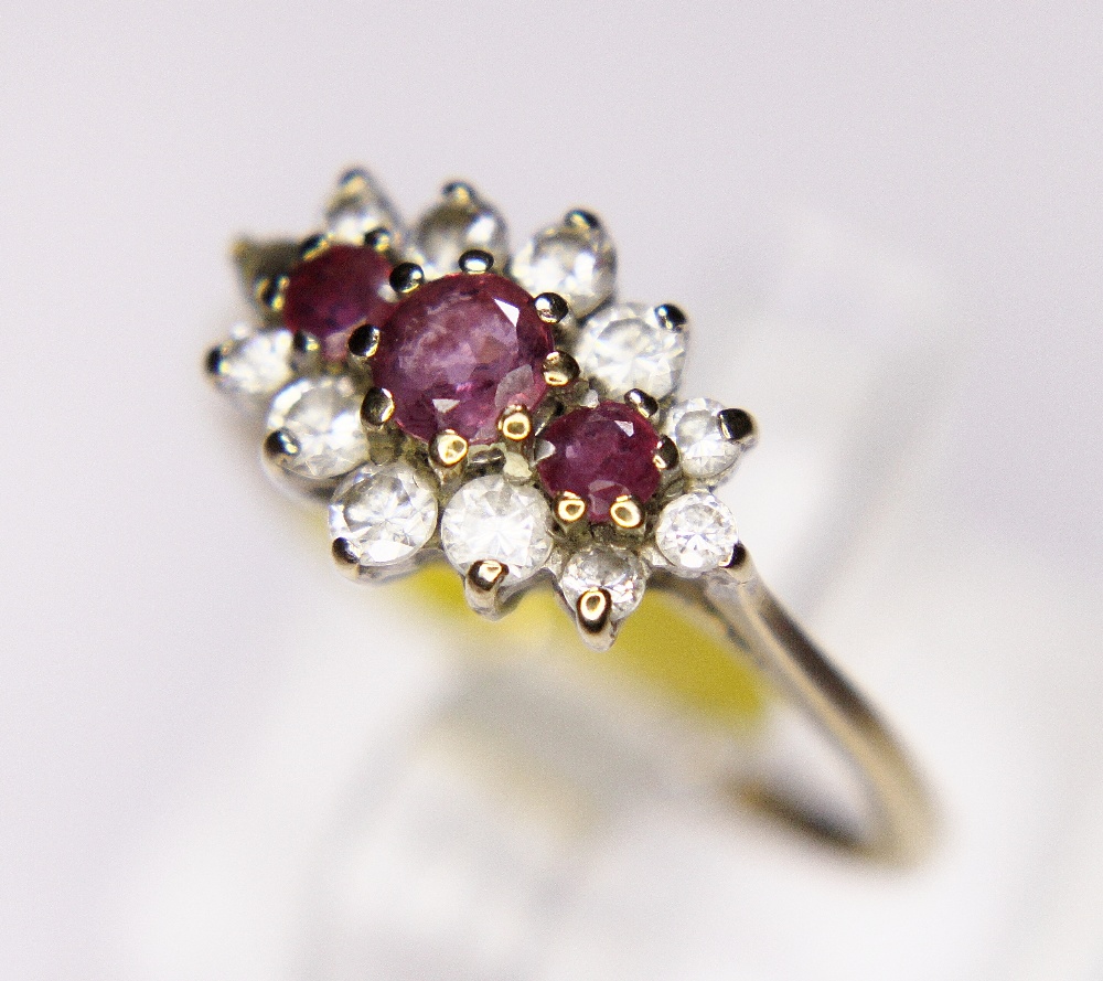 CLUSTER RING. 9ct gold ruby and CZ cluster ring, size M/N