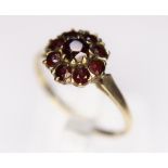 GOLD RING. 9ct gold garnet flower ring, size Q