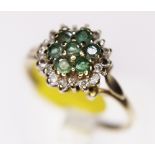 CLUSTER RING. 9ct gold emerald and diamond cluster ring, size L