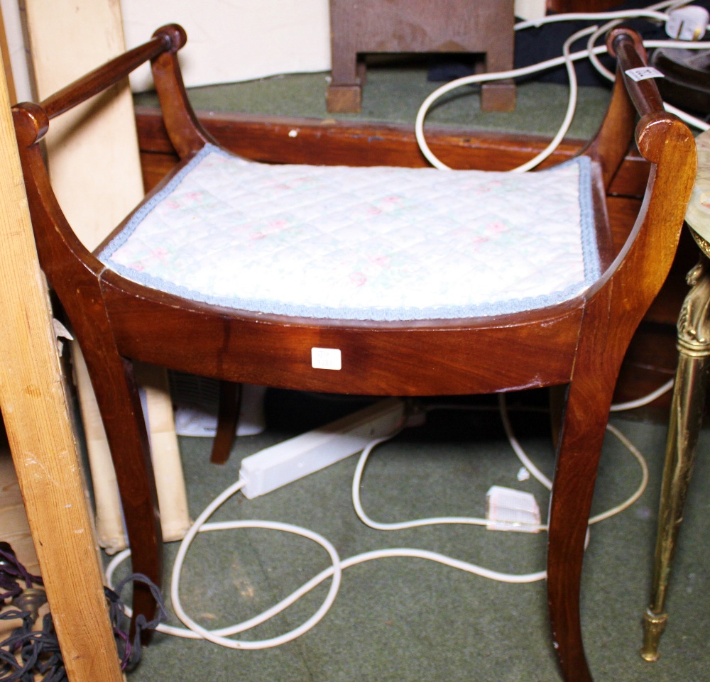 DRESSING TABLE STOOL. Mahogany dressing table stool with scrolled arms and upholstered seat