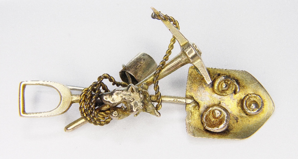 PROSPECTORS BROOCH. Yellow metal prospectors brooch with shovel, pick, rope and gold nugget detail