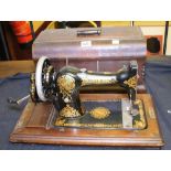 JONES SEWING MACHINE. Antique oak cased Jones hand powered sewing machine