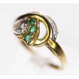 GOLD TWIST RING. 9ct yellow gold diamond and emerald set twist ring, size N