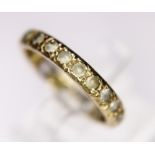 GOLD ETERNITY RING. 9ct yellow gold stone set eternity ring, size P